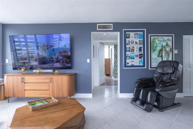 a living room with furniture and a painting on the wall