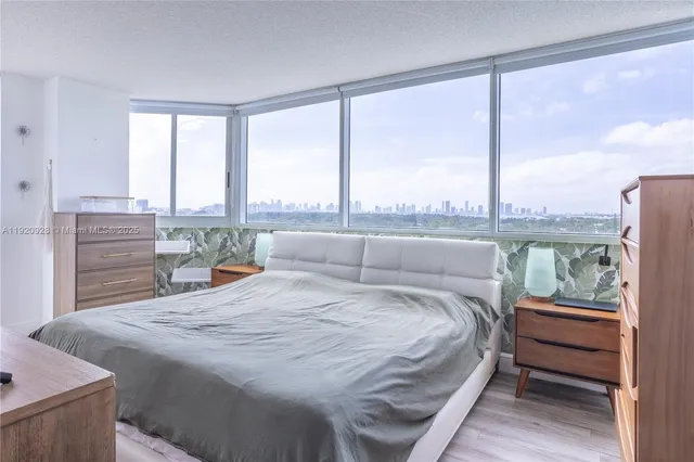 a kitchen with stainless steel appliances granite countertop a kitchen island hardwood floor and a sink