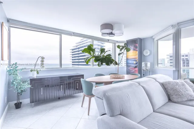 a living room with furniture and a floor to ceiling window