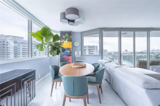 a dining room with furniture a rug and a large window