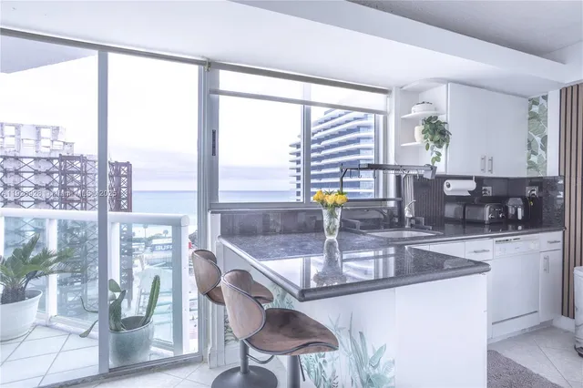 a kitchen with a large window and a sink