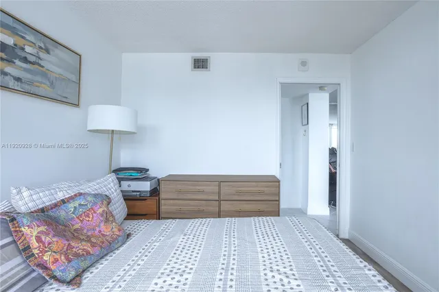 a bedroom with a bed and a lamp