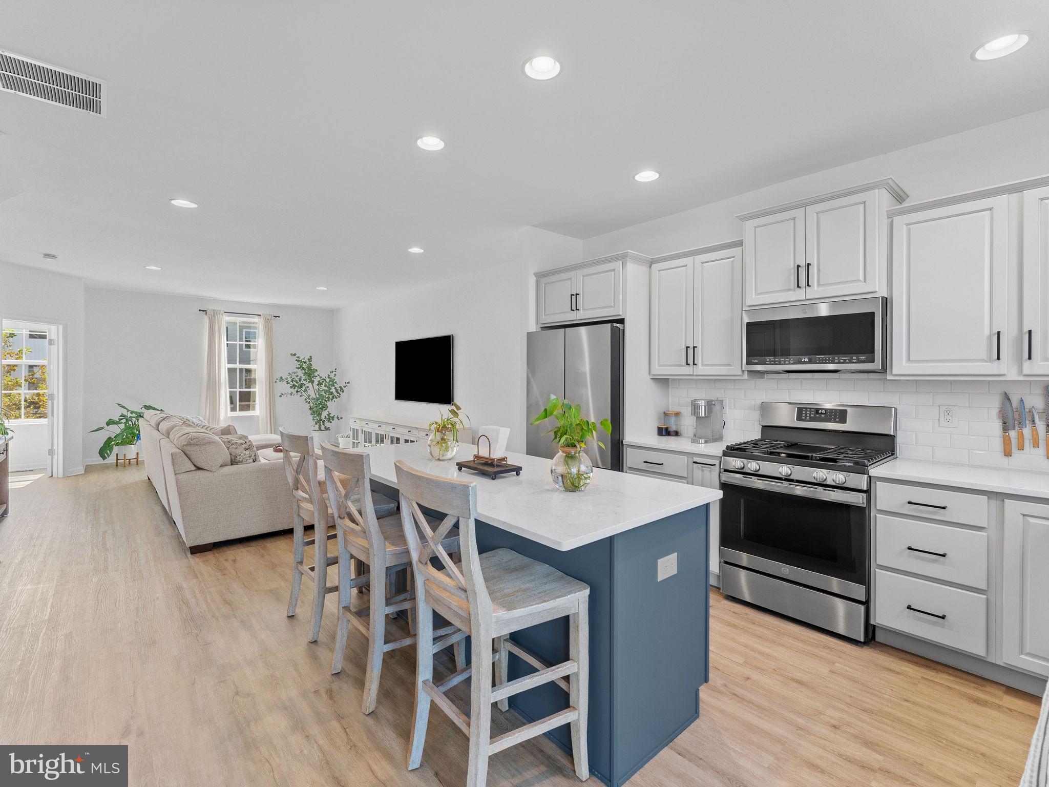14 Aviary Road West Deptford, NJ 08086 - Photo 11 of 39 a open kitchen with stainless steel appliances granite countertop a stove top oven a sink dishwasher a dining table and chairs with wooden floor