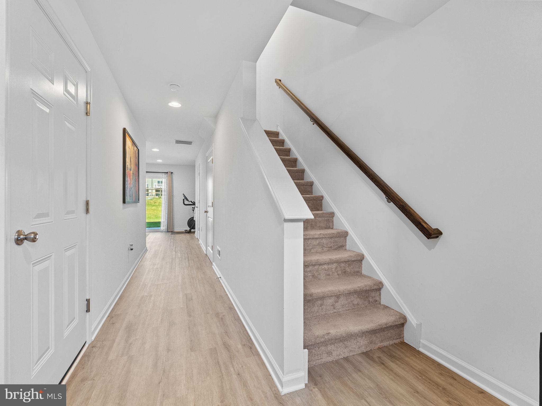 14 Aviary Road West Deptford, NJ 08086 - Photo 3 of 39 a view of a hallway with wooden floor and staircase