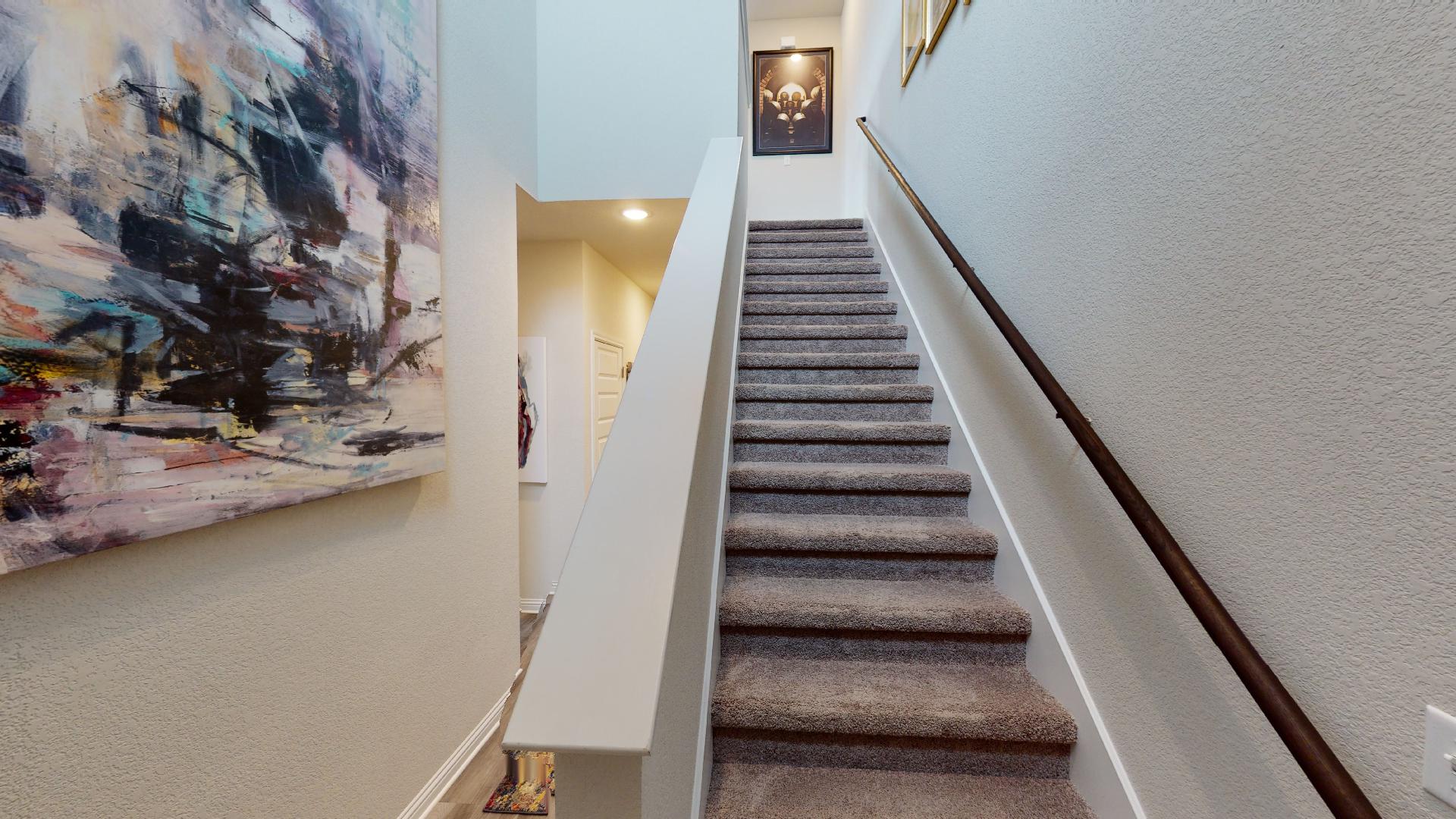8111 Springsteen Drive Austin, TX 78744 - Photo 2 of 10 Stairway with a textured wall and baseboards