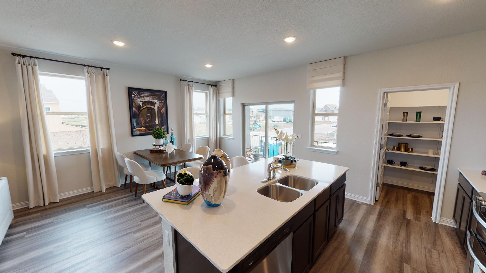 8111 Springsteen Drive Austin, TX 78744 - Photo 4 of 10 Kitchen with dark wood-style flooring, an island with sink, recessed lighting, stainless steel dishwasher, and healthy amount of natural light