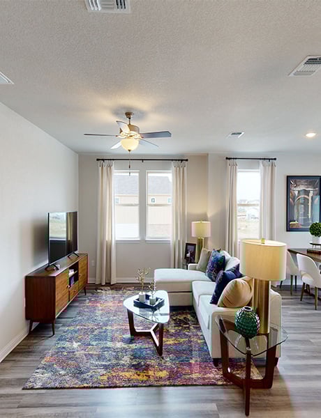 8111 Springsteen Drive Austin, TX 78744 - Photo 7 of 10 Living room with light wood-type flooring, plenty of natural light, a ceiling fan, and a textured ceiling