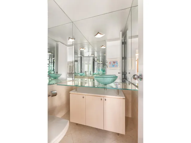 a bathroom with a bathtub sink vanity and mirror