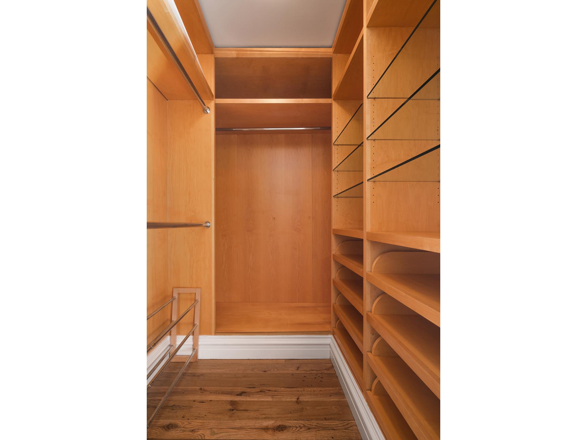 641 5th Avenue, Unit 42H Manhattan, NY 10022 - Photo 13 of 16 a view of walk in closet with empty racks