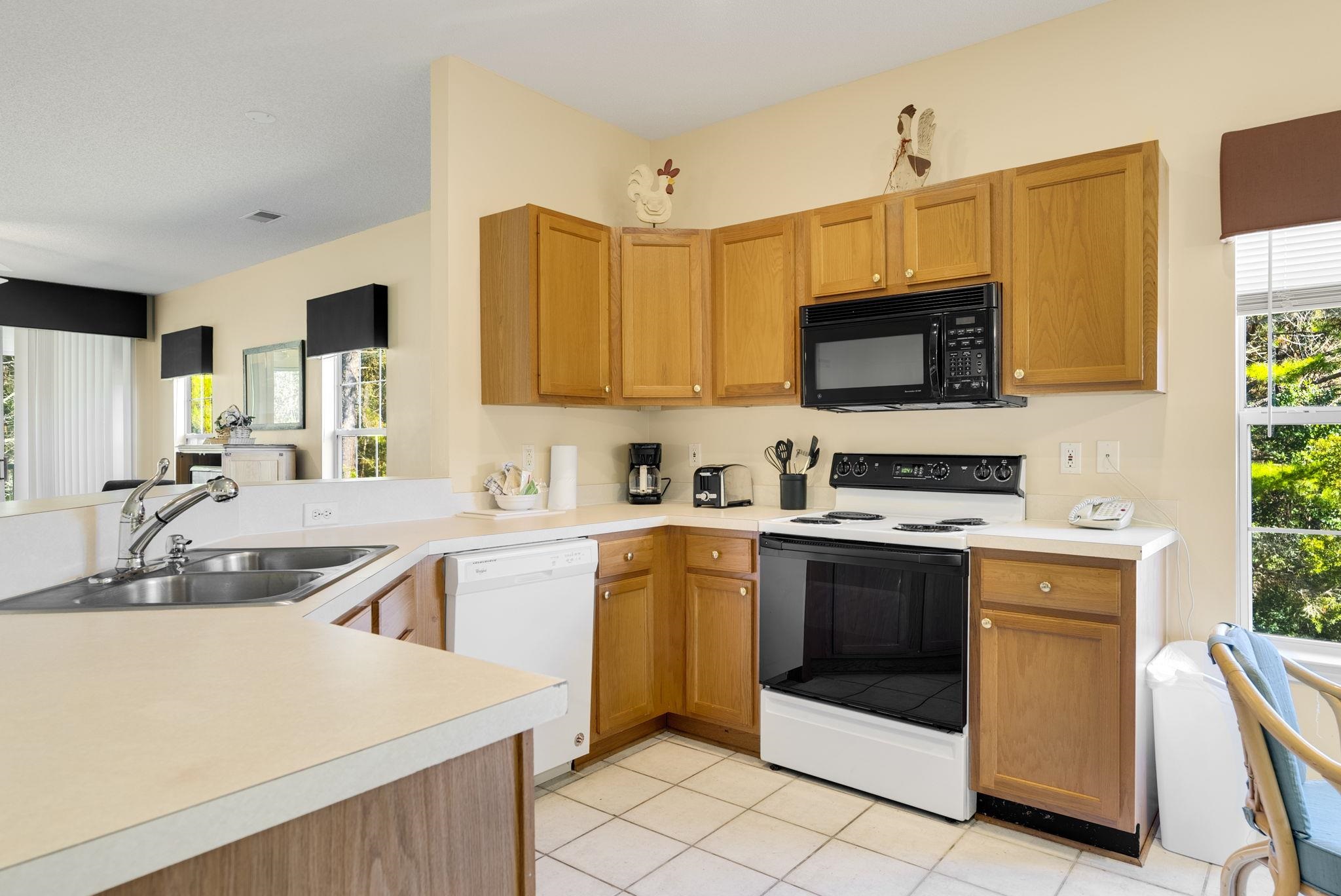 4499 Girvan Drive, Unit H Myrtle Beach, SC 29579 - Photo 17 of 35 Kitchen featuring white appliances, light countertops, healthy amount of natural light, and a peninsula