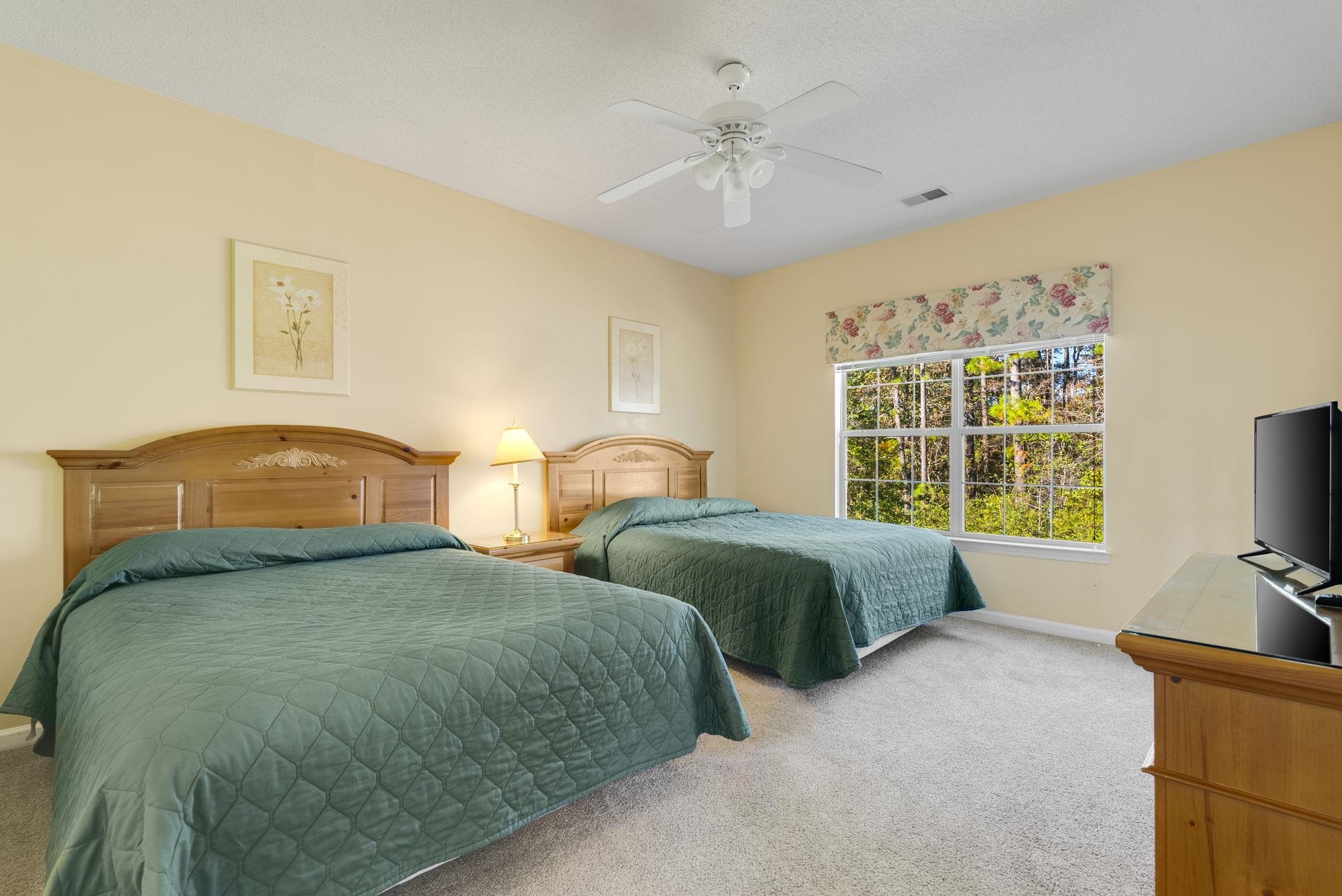 4499 Girvan Drive, Unit H Myrtle Beach, SC 29579 - Photo 28 of 35 Bedroom featuring light carpet and ceiling fan