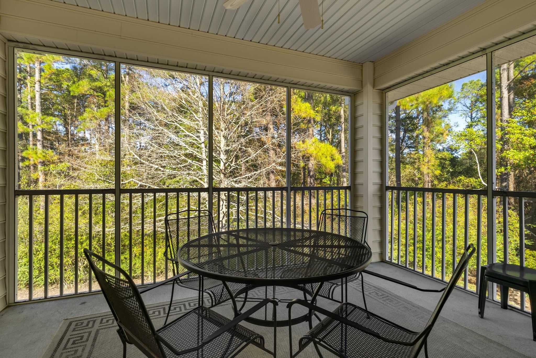 4499 Girvan Drive, Unit H Myrtle Beach, SC 29579 - Photo 29 of 35 Sunroom featuring a ceiling fan, outdoor dining space, a balcony, and plenty of natural light