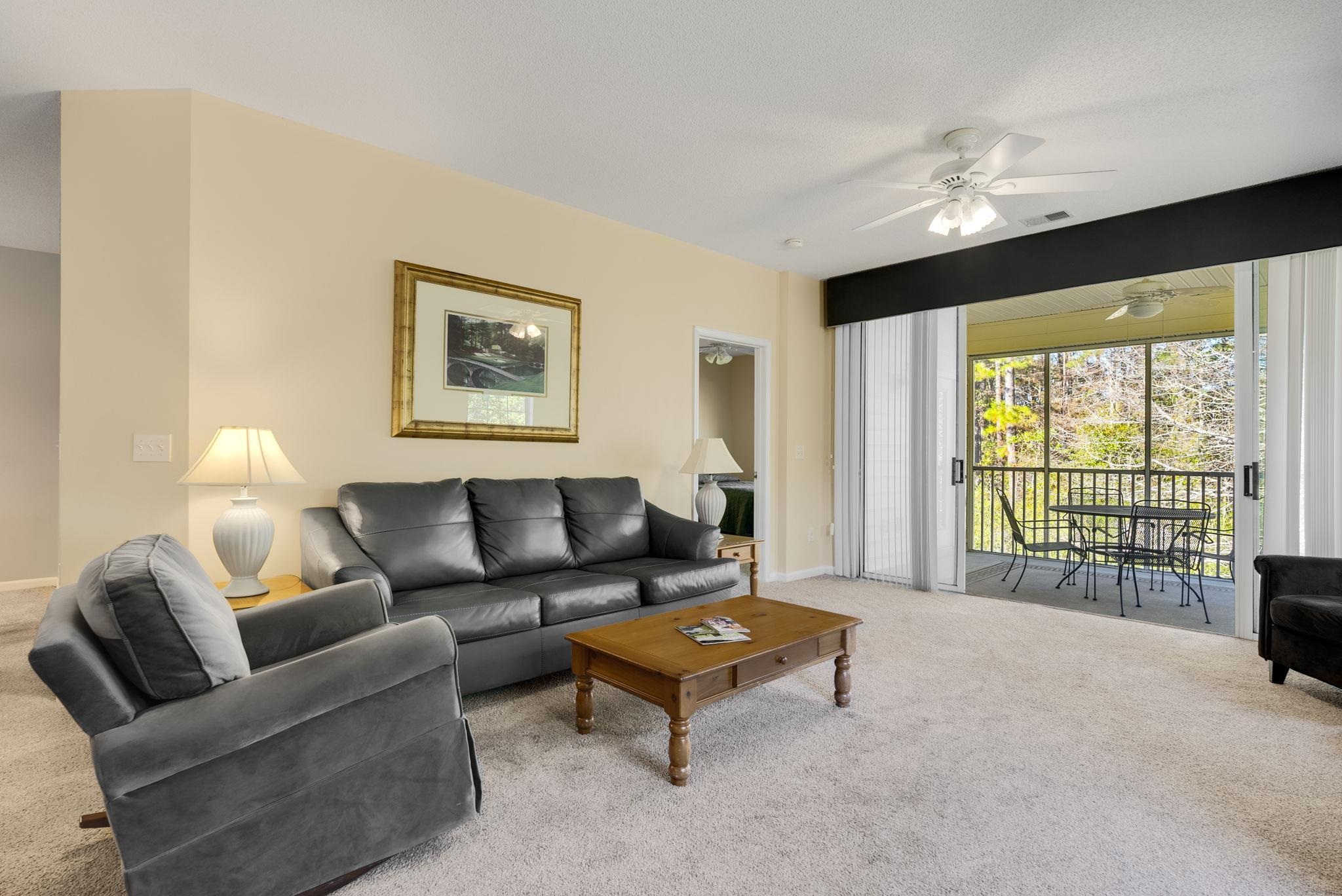 4499 Girvan Drive, Unit H Myrtle Beach, SC 29579 - Photo 10 of 35 Carpeted living room with a ceiling fan and baseboards