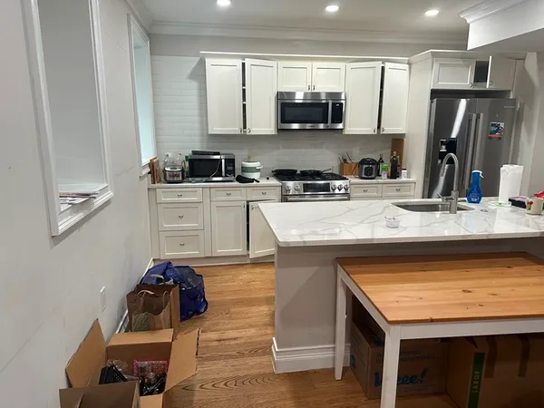 a kitchen with a sink stove and refrigerator