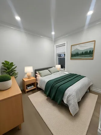a bedroom with a bed and a potted plant