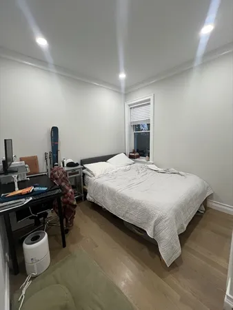 a bedroom with a bed a desk and chair