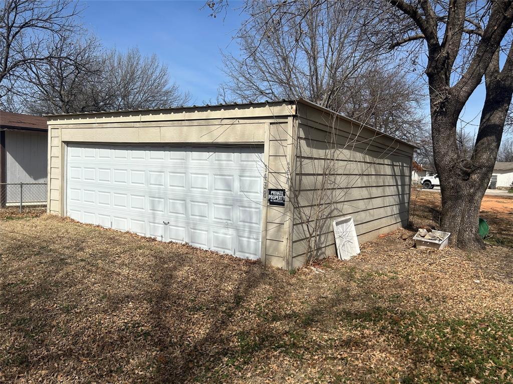 1438 Ave A Graham, TX 76450 - Photo 4 of 6 a front view of a house with a yard