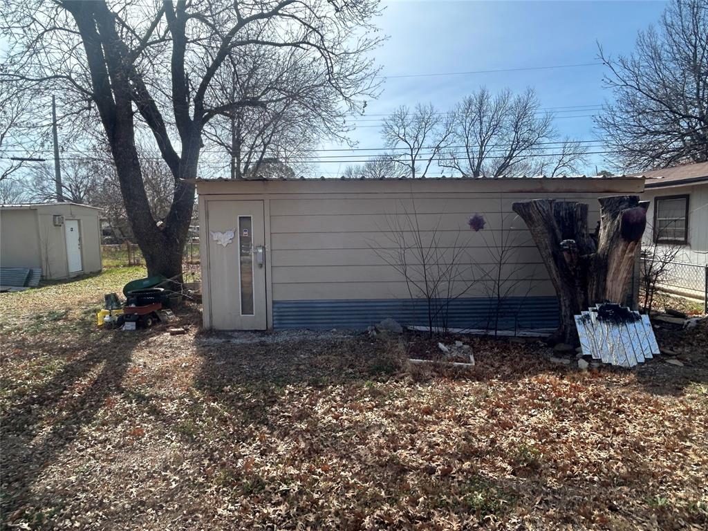 1438 Ave A Graham, TX 76450 - Photo 6 of 6 a view of a backyard with large trees