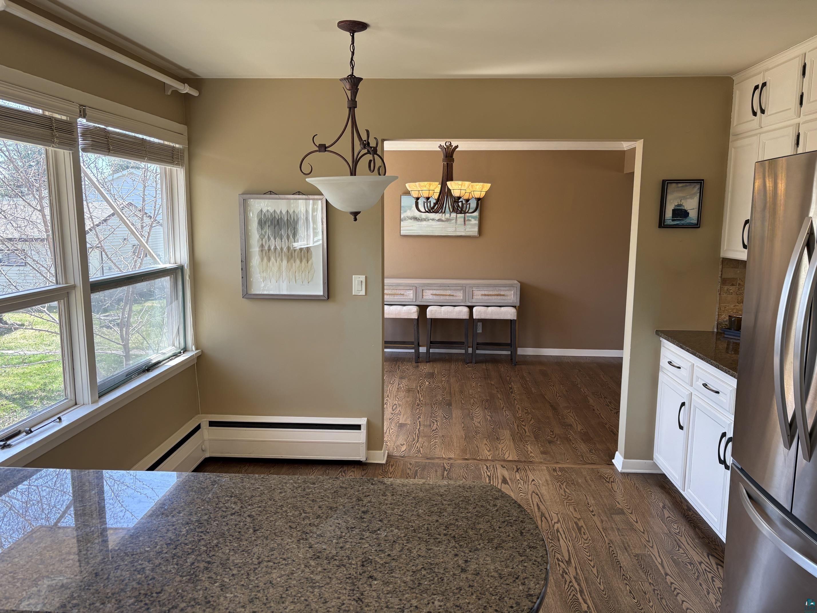 1918 West Kent Road Duluth, MN 55812 - Photo 10 of 42 Kitchen featuring white cabinetry, dark stone countertops, and a full-size stainless steel refrigerator