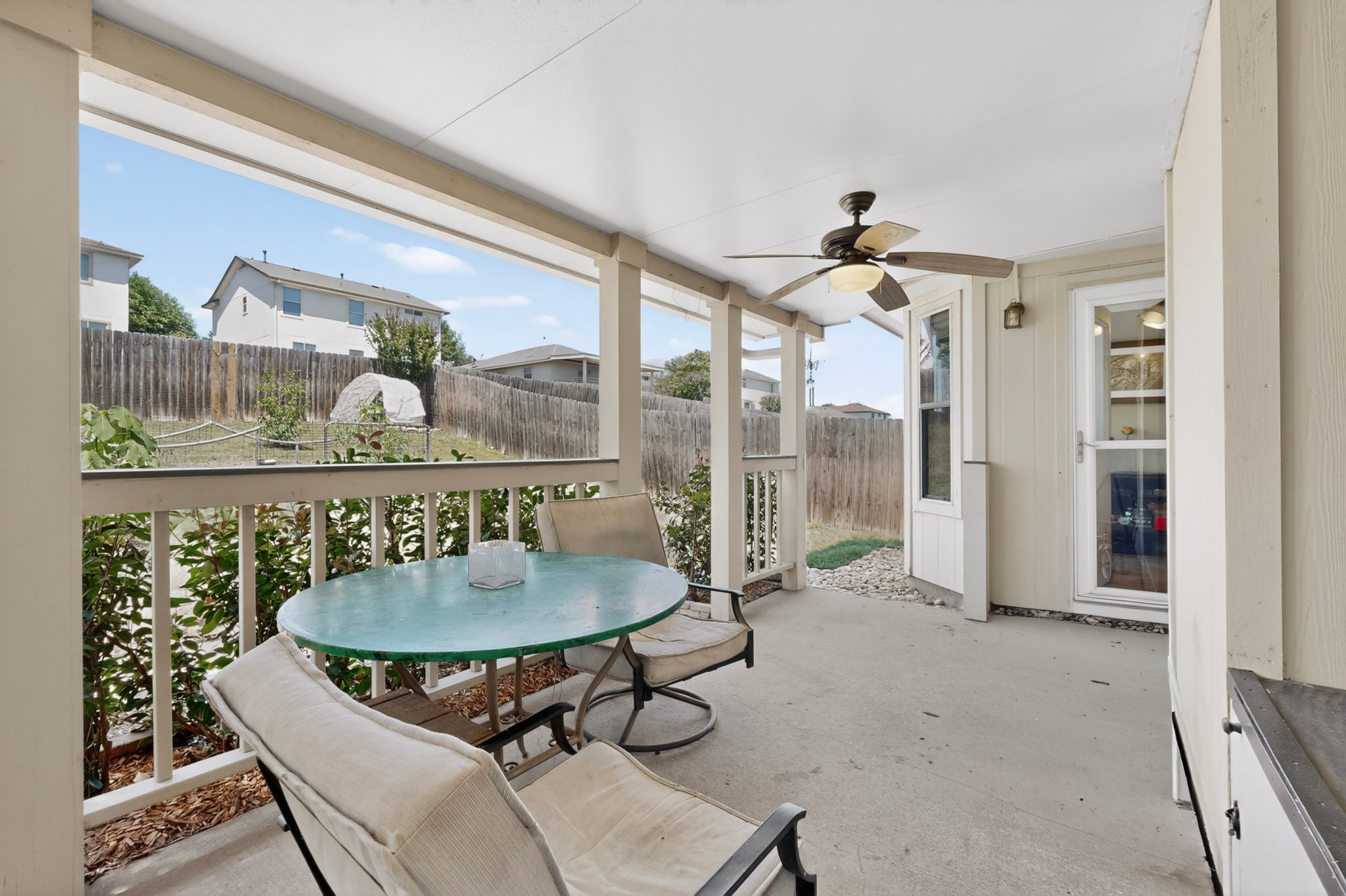 15104 Mimebark Way Austin, TX 78724 - Photo 33 of 38 Covered patio featuring a ceiling fan, concrete flooring, and a railing with vertical balusters
