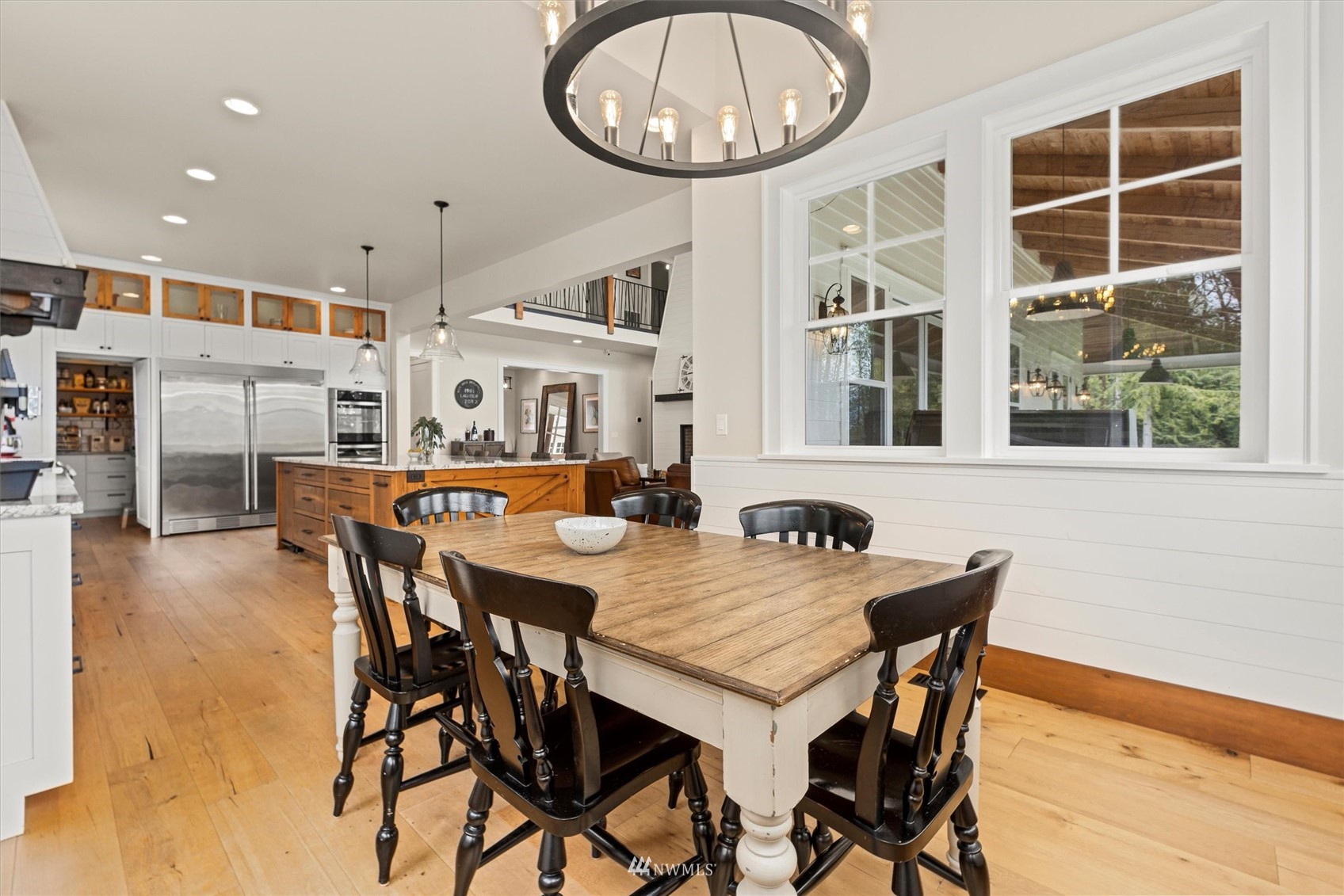 8209 Spada Road Snohomish, WA 98290 - Photo 16 of 39 a view of a dining room and livingroom with furniture front door and wooden floor