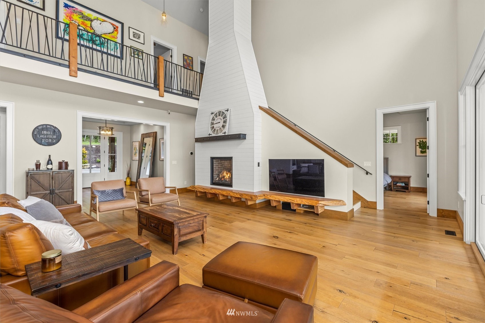 8209 Spada Road Snohomish, WA 98290 - Photo 9 of 39 a living room with furniture fireplace and a flat screen tv