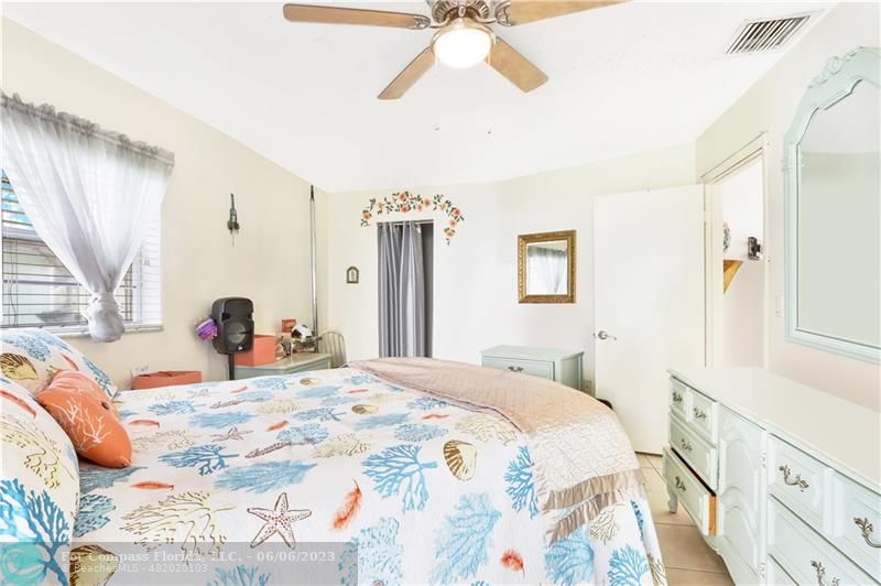 1128 Hernando Street Fort Pierce, FL 34949 - Photo 13 of 46 a bedroom with a bed and a window