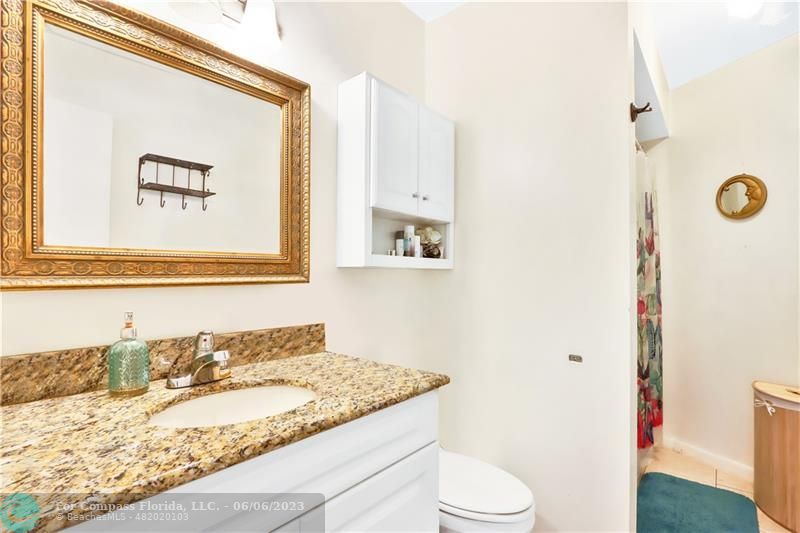 1128 Hernando Street Fort Pierce, FL 34949 - Photo 14 of 46 a bathroom with a granite countertop sink and a mirror