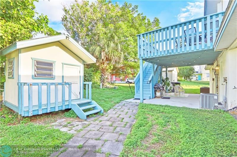 1128 Hernando Street Fort Pierce, FL 34949 - Photo 17 of 46 a view of a house with a yard and deck