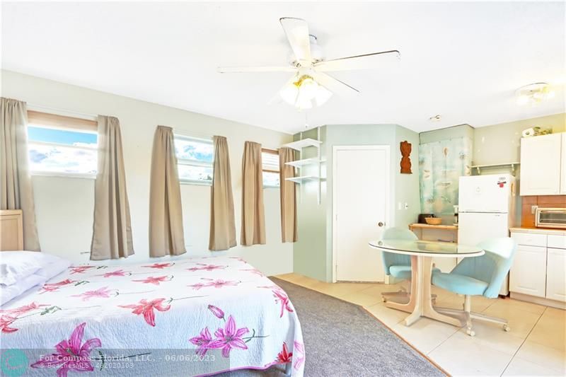 1128 Hernando Street Fort Pierce, FL 34949 - Photo 21 of 46 a bedroom with a bed and a chandelier