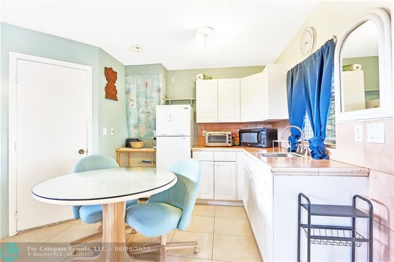 1128 Hernando Street Fort Pierce, FL 34949 - Photo 25 of 46 a dining room with furniture and a chandelier