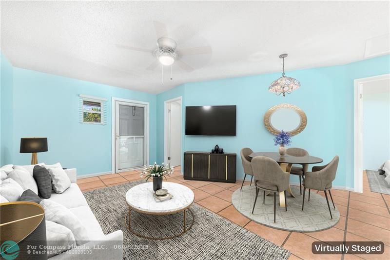 1128 Hernando Street Fort Pierce, FL 34949 - Photo 27 of 46 a living room with furniture a flat screen tv and kitchen view