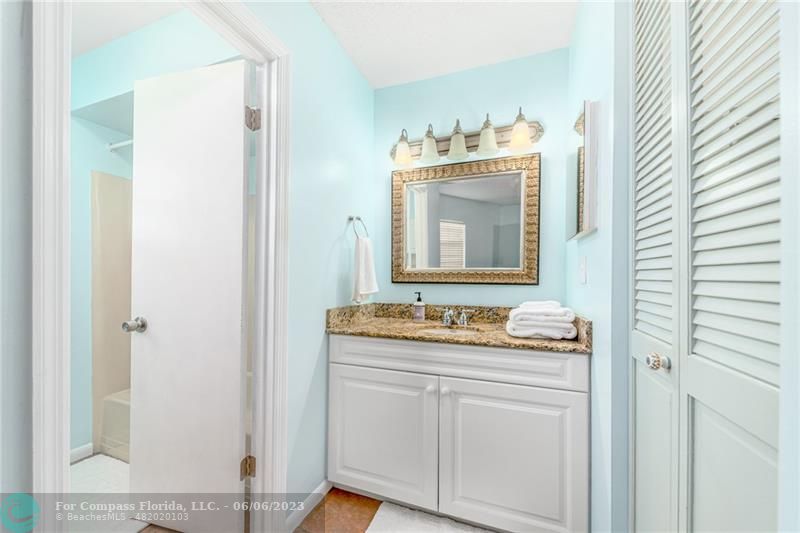 1128 Hernando Street Fort Pierce, FL 34949 - Photo 32 of 46 a bathroom with a sink vanity and mirror