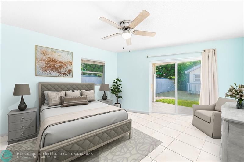 1128 Hernando Street Fort Pierce, FL 34949 - Photo 34 of 46 a bedroom with a bed and a chandelier