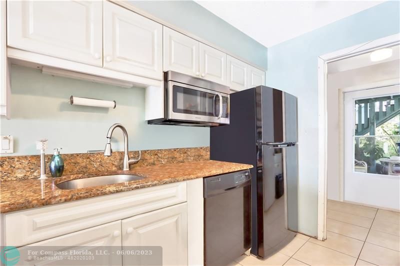 1128 Hernando Street Fort Pierce, FL 34949 - Photo 7 of 46 a kitchen with stainless steel appliances granite countertop a refrigerator and a sink