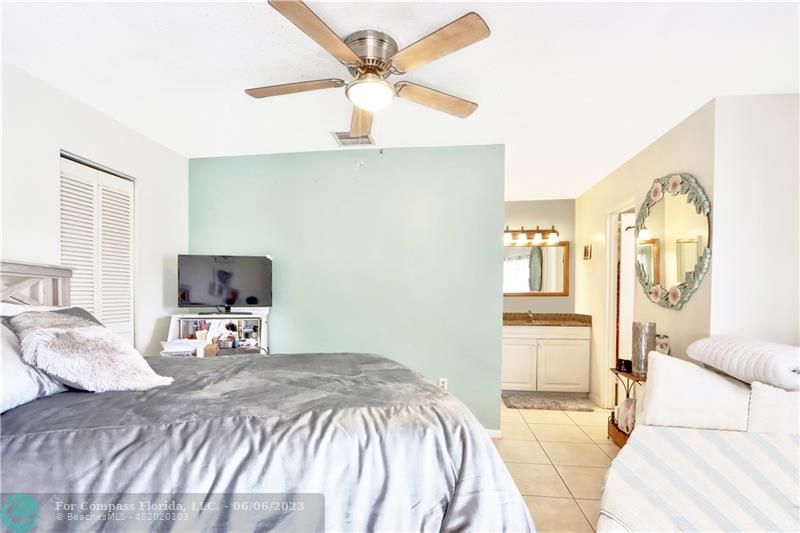 1128 Hernando Street Fort Pierce, FL 34949 - Photo 9 of 46 a bedroom with a bed and a flat screen tv