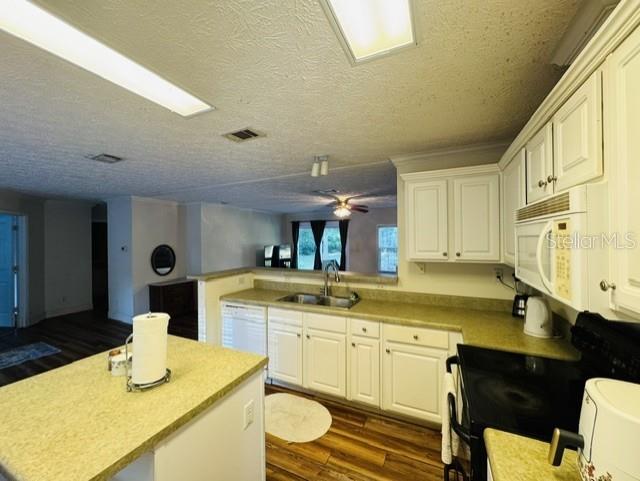 11817 Southwest 58th Street Webster, FL 33597 - Photo 7 of 46 a kitchen with a sink cabinets and wooden floor