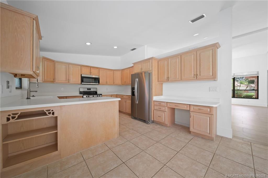 2284 Southwest Spoonbill Drive Palm City, FL 34990 - Photo 11 of 30 a kitchen with granite countertop cabinets and white appliances