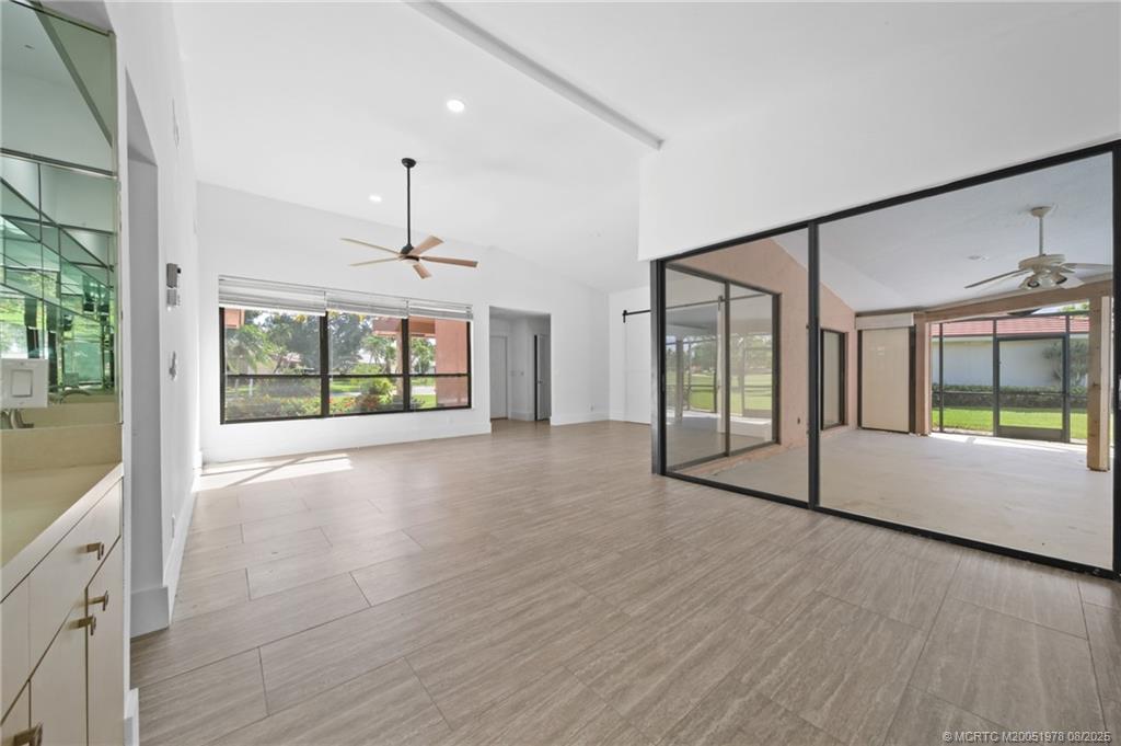 2284 Southwest Spoonbill Drive Palm City, FL 34990 - Photo 13 of 30 an empty room with wooden floor and windows