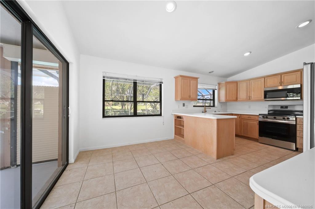 2284 Southwest Spoonbill Drive Palm City, FL 34990 - Photo 15 of 30 a kitchen with stainless steel appliances granite countertop a refrigerator sink and cabinets