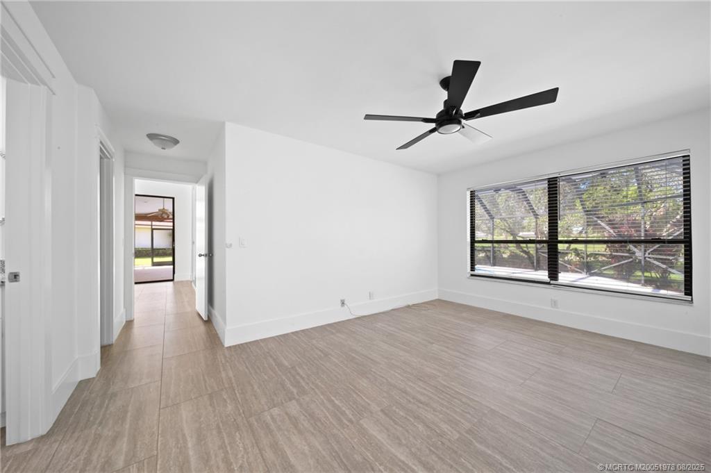 2284 Southwest Spoonbill Drive Palm City, FL 34990 - Photo 16 of 30 wooden floor in an empty room with a window