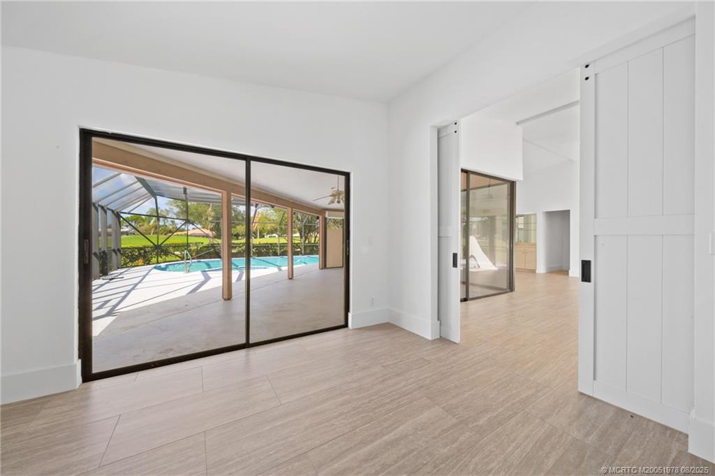 2284 Southwest Spoonbill Drive Palm City, FL 34990 - Photo 17 of 30 a view of a big room with wooden floor and windows