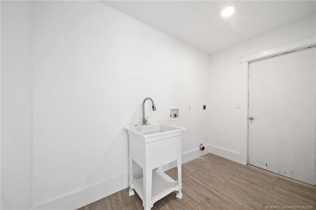 2284 Southwest Spoonbill Drive Palm City, FL 34990 - Photo 21 of 30 a white room with a sink and mirror