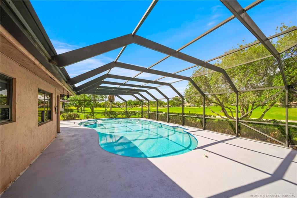 2284 Southwest Spoonbill Drive Palm City, FL 34990 - Photo 27 of 30 a view of a swimming pool with a patio