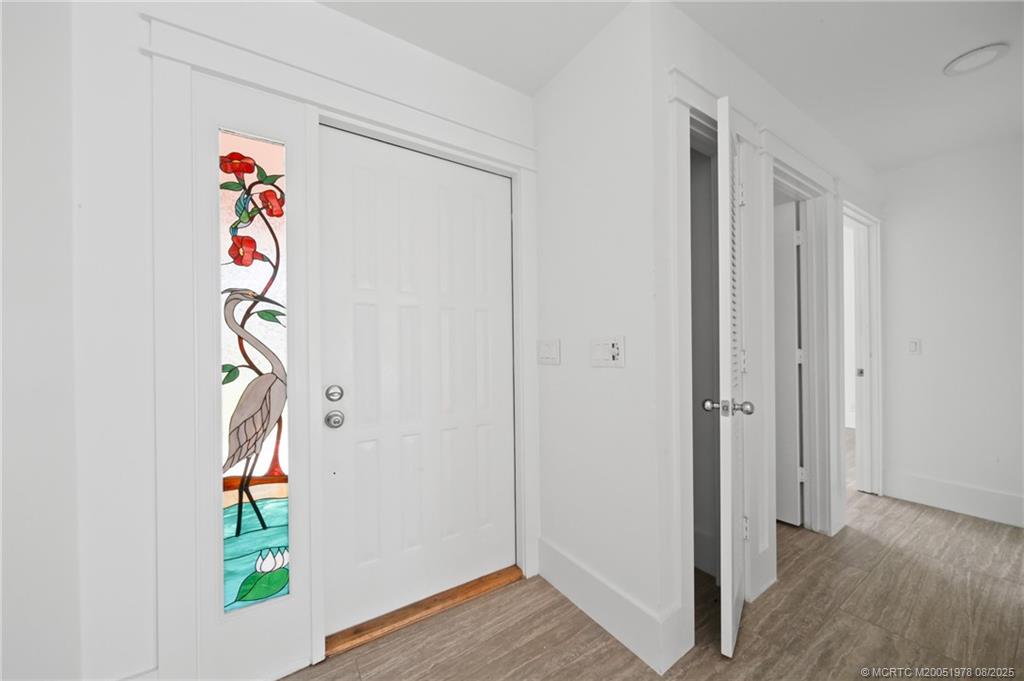 2284 Southwest Spoonbill Drive Palm City, FL 34990 - Photo 8 of 30 a view of an entryway with wooden floor