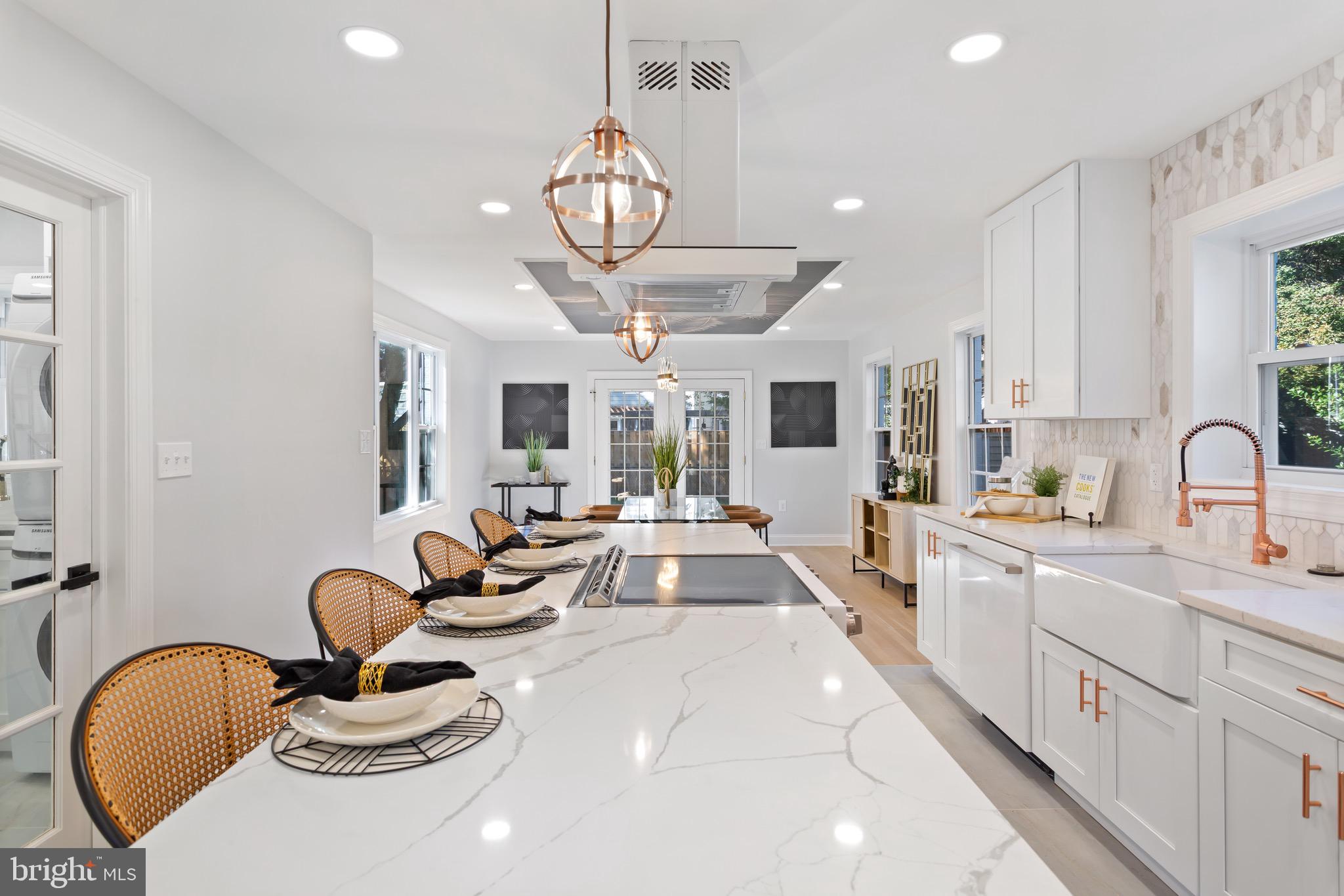 617 Greenbrier Drive Silver Spring, MD 20910 - Photo 11 of 70 a large kitchen with stainless steel appliances a stove a sink dishwasher a dining table and chairs with wooden floor