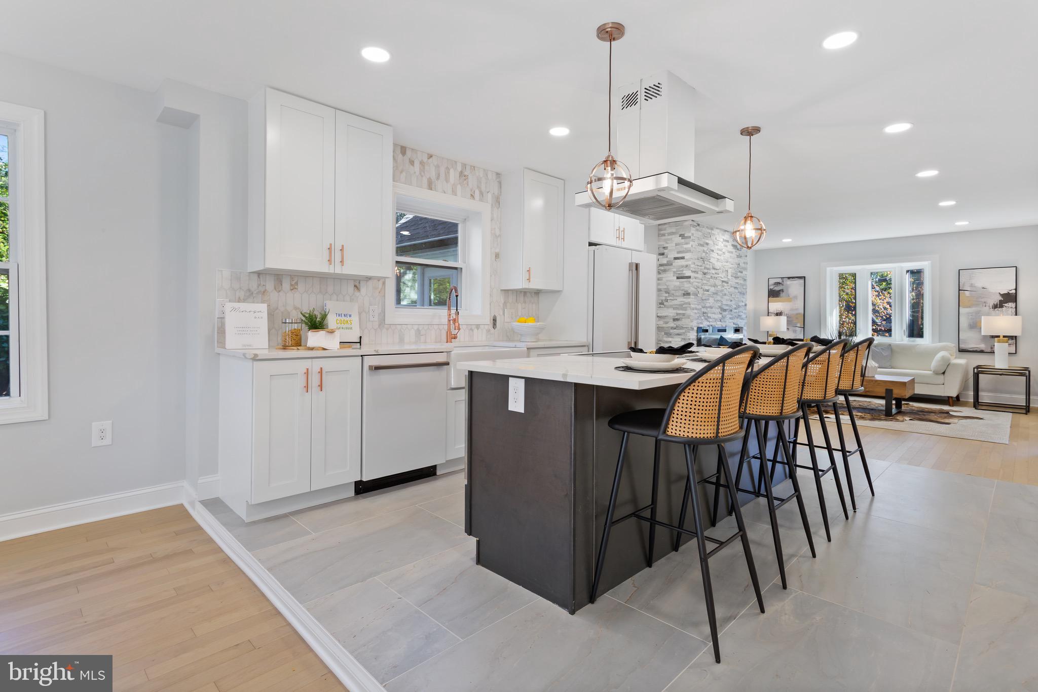 617 Greenbrier Drive Silver Spring, MD 20910 - Photo 12 of 70 a open kitchen with stainless steel appliances granite countertop a stove top oven a sink dishwasher and white cabinets with wooden floor