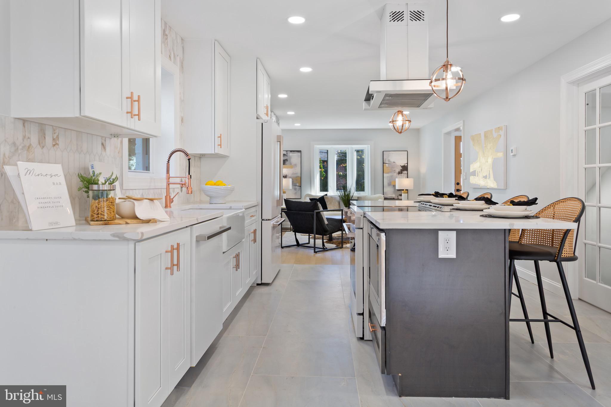 617 Greenbrier Drive Silver Spring, MD 20910 - Photo 14 of 70 a kitchen with stainless steel appliances kitchen island granite countertop a table chairs in it and white cabinets