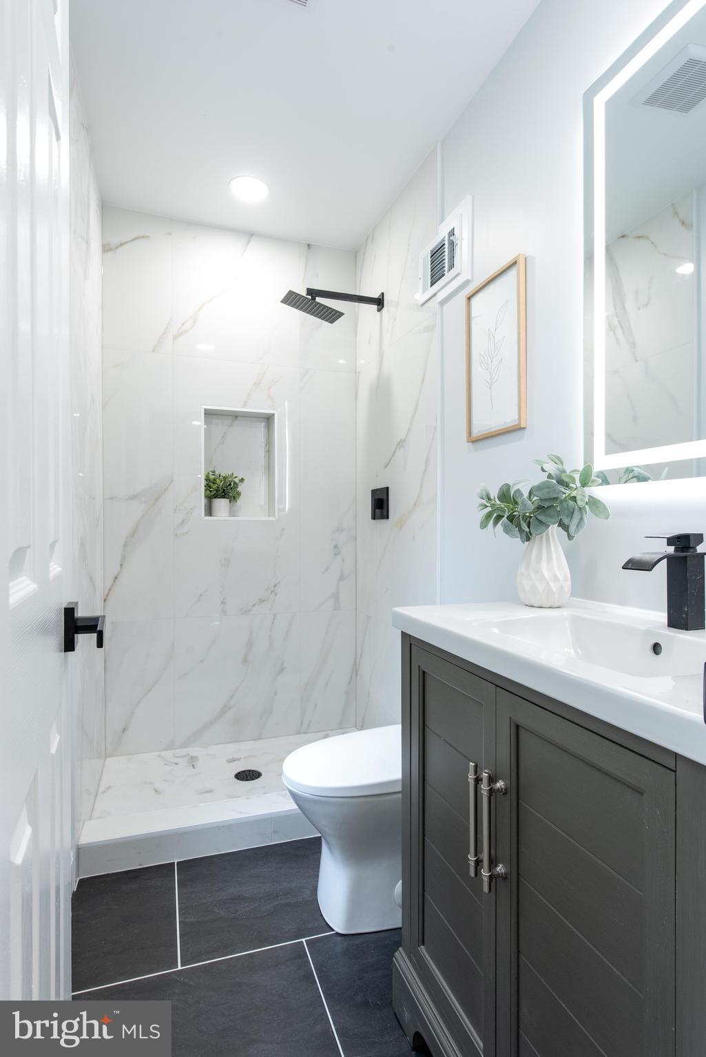 617 Greenbrier Drive Silver Spring, MD 20910 - Photo 33 of 70 a bathroom with a sink toilet a mirror and shower