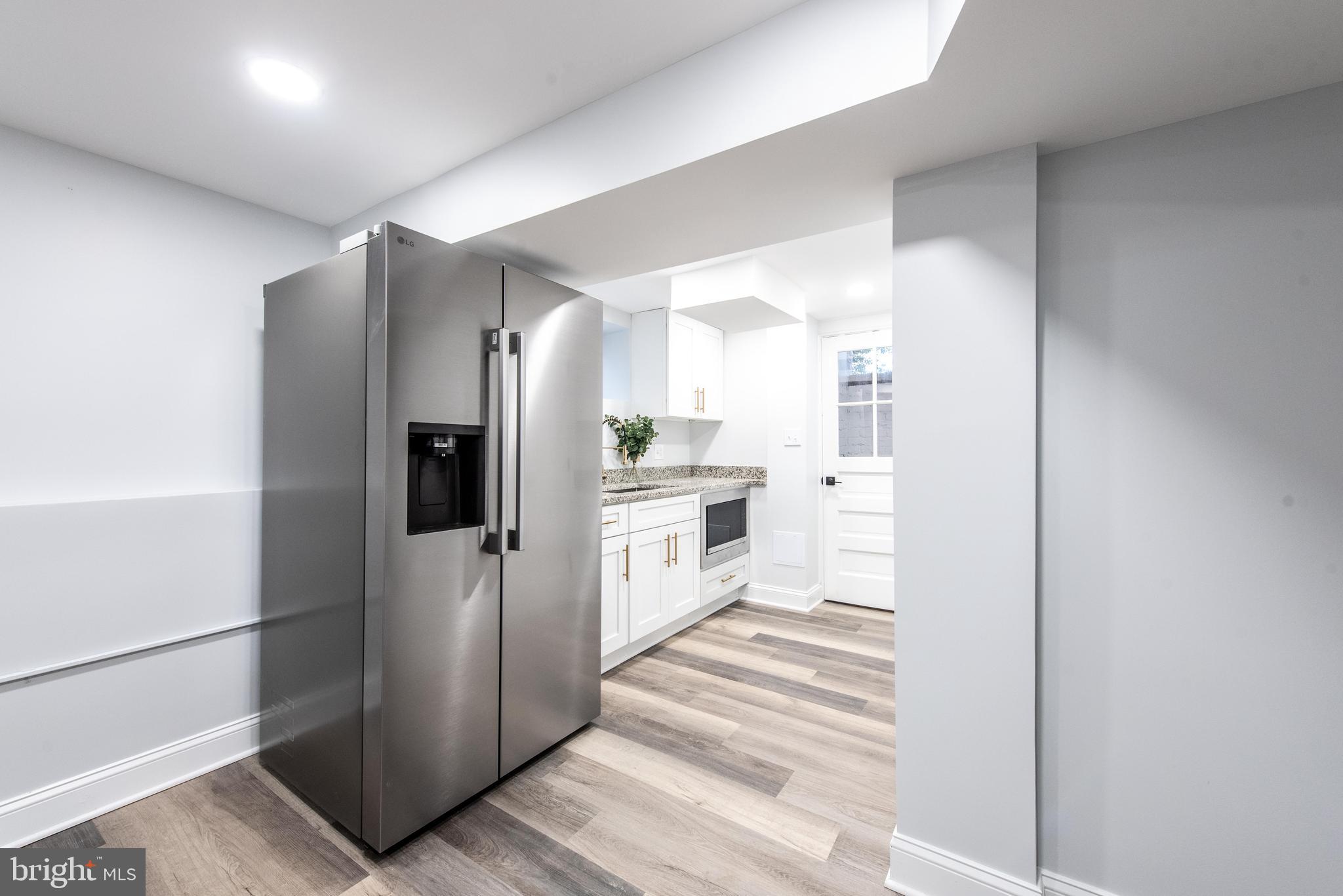 617 Greenbrier Drive Silver Spring, MD 20910 - Photo 52 of 70 a kitchen with stainless steel appliances a refrigerator and white cabinets